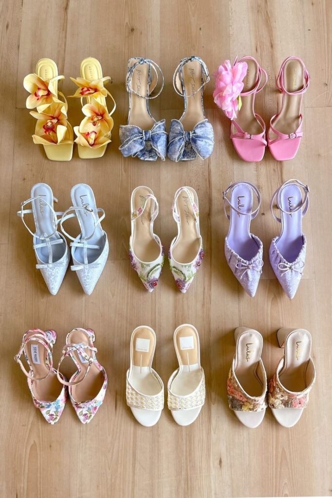 Colorful women's high heels and sandals arranged on wooden floor. Floral, bow, and lace designs perfect for spring fashion.