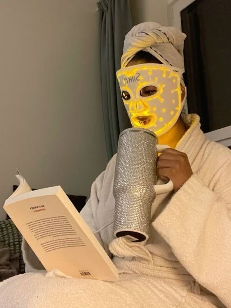 You Dont Need a New Life Just New Habits 💫✨ Person relaxing in a robe, wearing an LED mask, reading a book, and holding a glittery mug. Cozy and self-care vibes. - Handy Home Person relaxing in a robe, wearing an LED mask, reading a book, and holding a glittery mug. Cozy and self-care vibes.