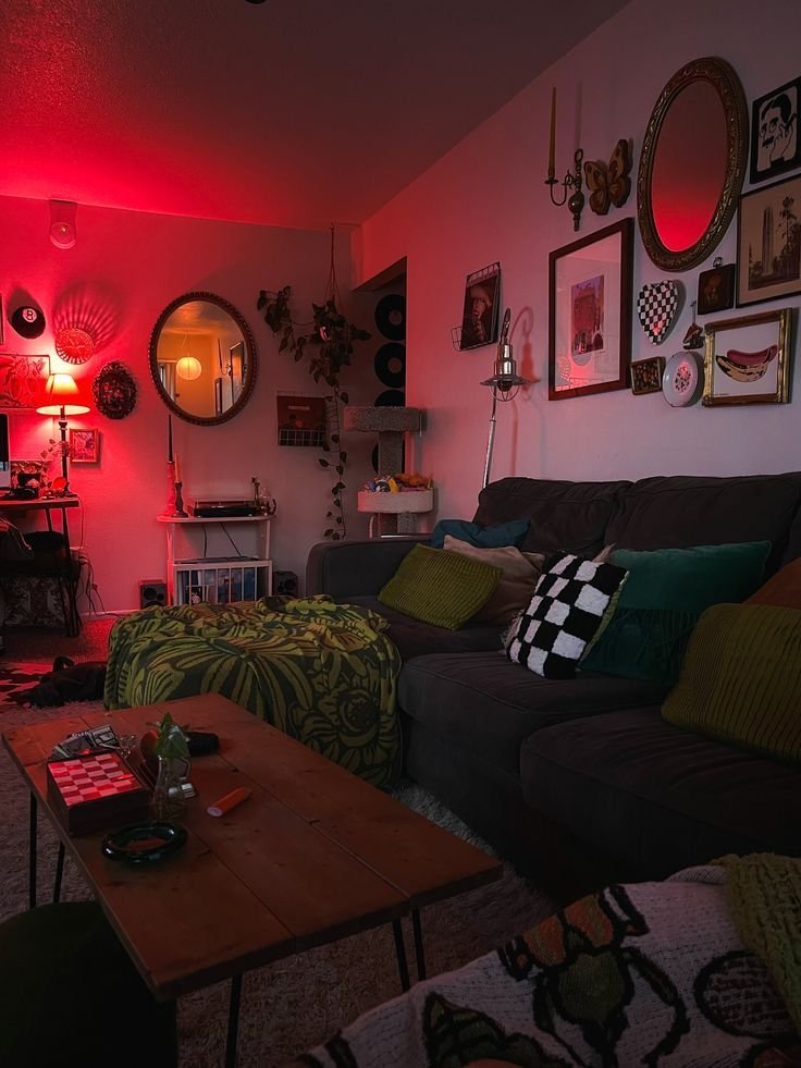 Cozy living room with dim red lighting, vintage decor, and plush seating, creating a warm and inviting ambiance.