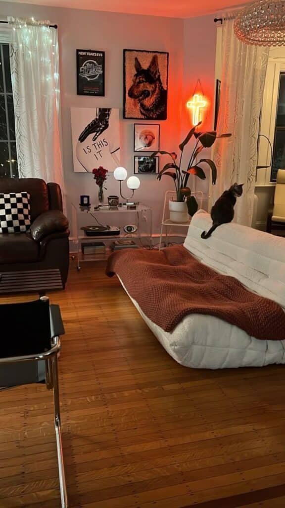 Cozy living room with modern decor, art-filled walls, comfy sofa, and a curious cat. Warm, stylish ambiance with soft lighting.