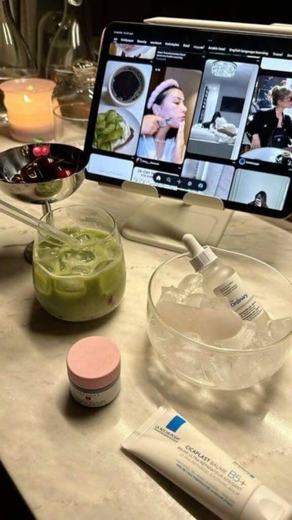 🤍 1 Cozy skincare setup with a tablet, green drink, cherries, and beauty products on a marble table, lit by a candle. Ideal self-care vibe. - Handy Home Cozy skincare setup with a tablet, green drink, cherries, and beauty products on a marble table, lit by a candle. Ideal self-care vibe.