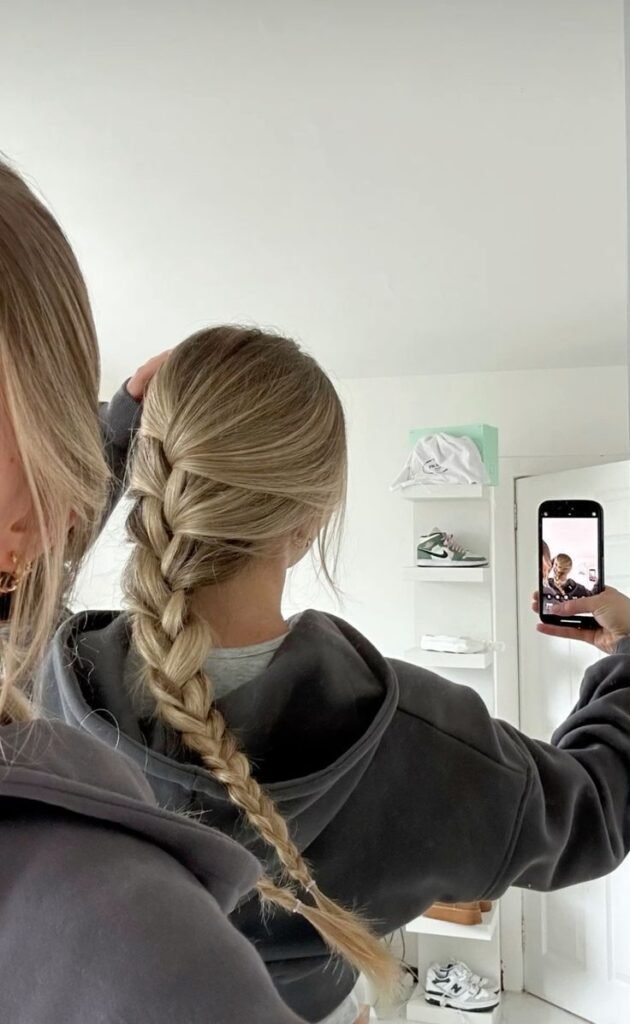 🫧 Woman with long blonde braid takes mirror selfie in cozy hoodie, capturing casual everyday style in a minimalist room. - Handy Home Woman with long blonde braid takes mirror selfie in cozy hoodie, capturing casual everyday style in a minimalist room.