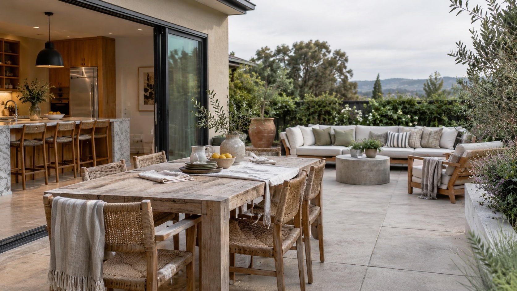 Create a Functional Entertaining Layout Wide view of outdoor dining near the kitchen and a separate lounge zone with clear circulation paths - Handy Home Wide view of outdoor dining near the kitchen and a separate lounge zone with clear circulation paths