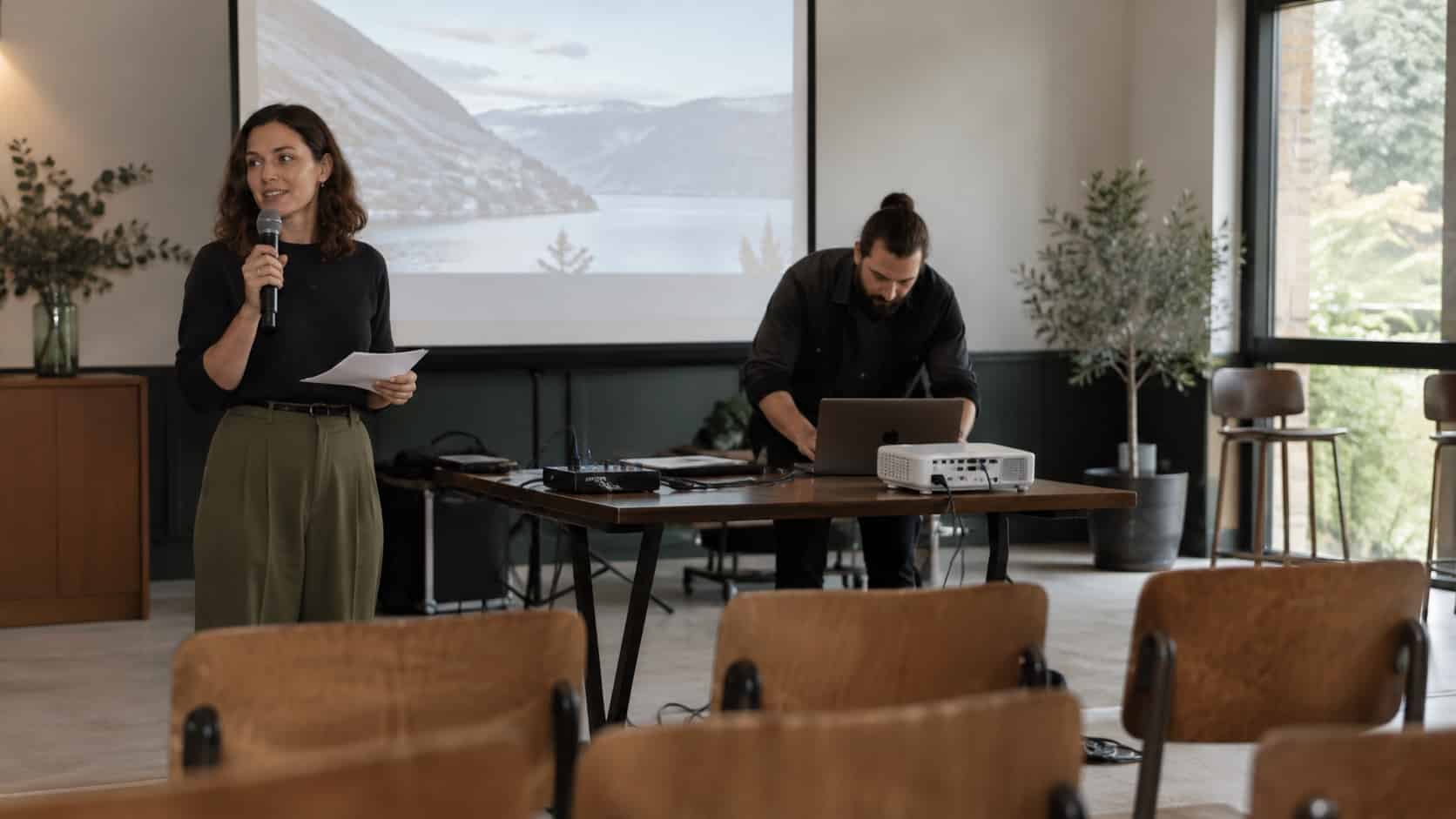 Allow Time for Setup and Testing A presenter and AV technician running a pre-event rehearsal with laptop, projector and microphone - Handy Home A presenter and AV technician running a pre-event rehearsal with laptop, projector and microphone