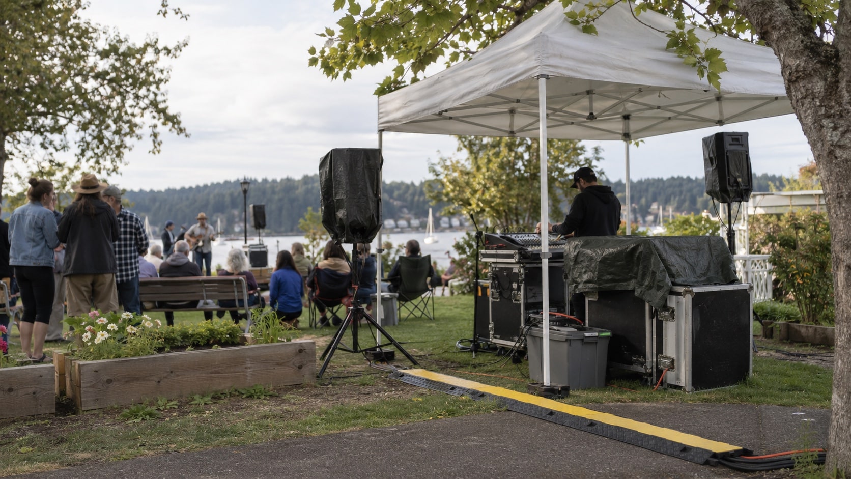 Outdoor Event Planning A small outdoor community event setup with weather-protected audio gear, secure cable covers and shaded equipment - Handy Home A small outdoor community event setup with weather-protected audio gear, secure cable covers and shaded equipment