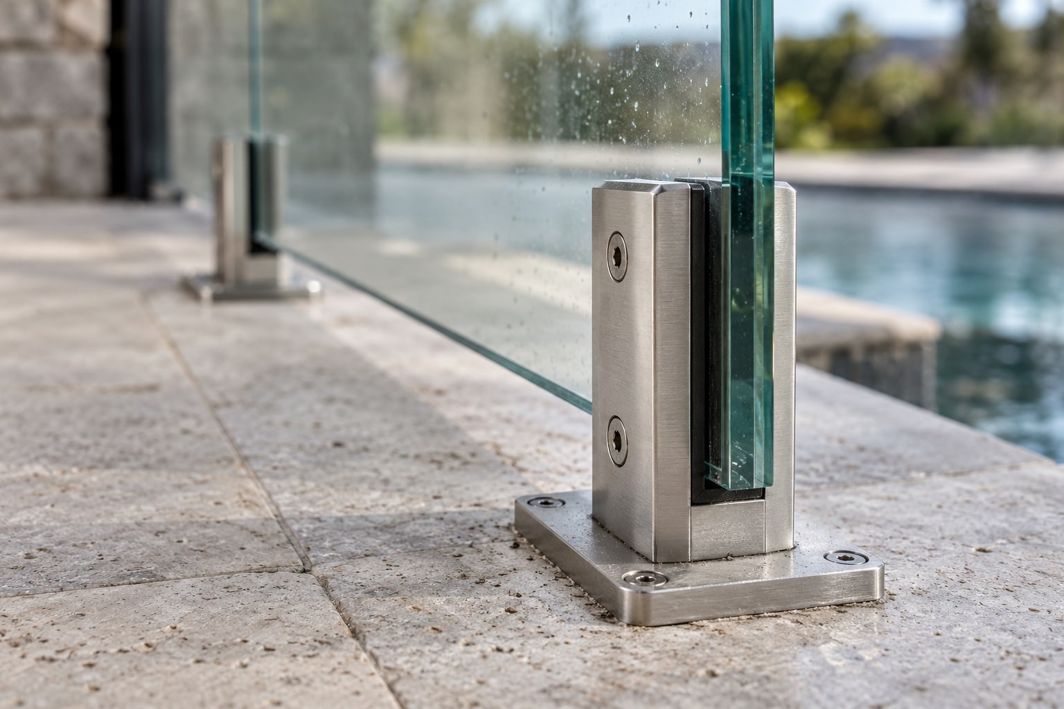 Safety Glass and Outdoor Hardware Detail Close-up of thick safety glass secured by brushed stainless-steel outdoor hardware - Handy Home Close-up of thick safety glass secured by brushed stainless-steel outdoor hardware